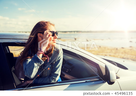 happy teenage girl or young woman in car happy teenage girl or young woman in car 45496135