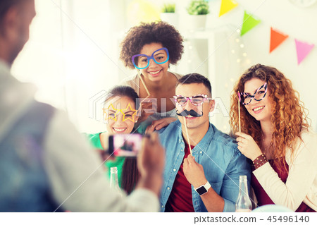 friends or team photographing at office party friends or team photographing at office party 45496140