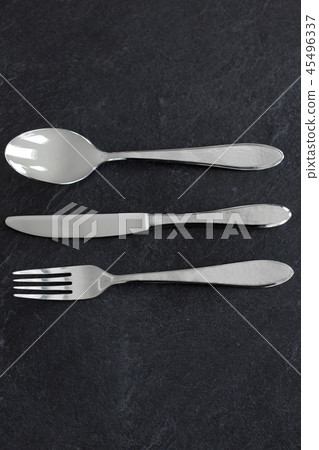 close up of fork, knife and spoon on table close up of fork, knife and spoon on table 45496337