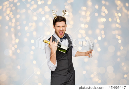man with bottle of champagne at christmas party man with bottle of champagne at christmas party 45496447