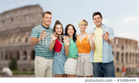 happy friends showing ok hand sign over coliseum happy friends showing ok hand sign over coliseum 45496449