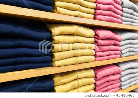 close up of shelves with clothes at clothing store 45496465