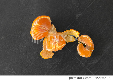 close up of peeled mandarin on slate table top 45496522