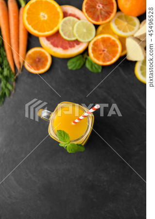 mason jar glass of fruit juice on slate table top 45496528