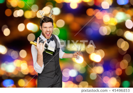 man with bottle of champagne at christmas party 45496853