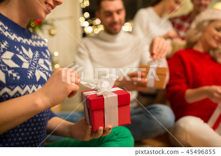 close up of friends opening christmas gifts close up of friends opening christmas gifts 45496855