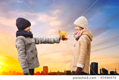 kids with autumn leaves over tallinn city sunset kids with autumn leaves over tallinn city sunset 45496978