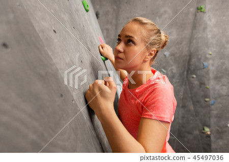 young woman exercising at indoor climbing gym 45497036