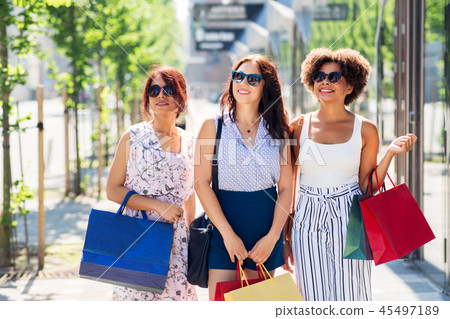 happy women with shopping bags in city happy women with shopping bags in city 45497189