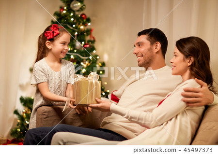 happy family with christmas present at home 45497373
