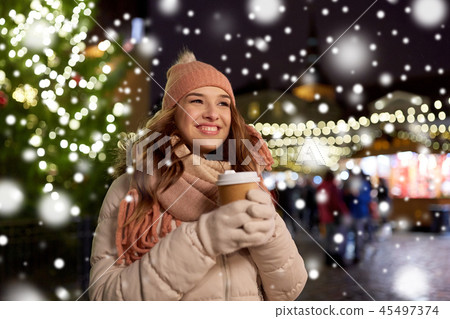 happy young woman with coffee at christmas market happy young woman with coffee at christmas market 45497374