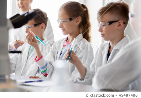 teacher and students studying chemistry at school 45497496