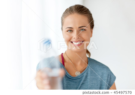 happy woman showing bottle of water happy woman showing bottle of water 45497570