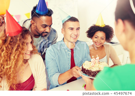 team greeting colleague at office birthday party team greeting colleague at office birthday party 45497674