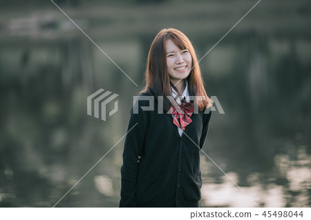 Portrait of asian japanese school girl costume looking at park outdoor film vintage style Portrait of asian japanese school girl costume looking at park outdoor film vintage style 45498044