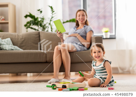 happy baby girl playing with toy blocks at home happy baby girl playing with toy blocks at home 45498079