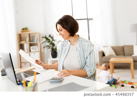 mother working at laptop and baby boy at home mother working at laptop and baby boy at home 45498357