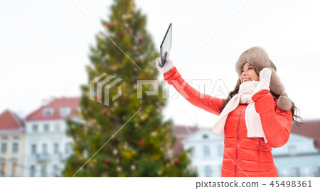 woman with tablet pc over christmas tree woman with tablet pc over christmas tree 45498361