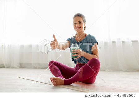 woman with cup of smoothie at yoga studio 45498603