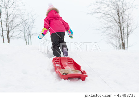 little girl with sleds on snow hill in winter 45498735
