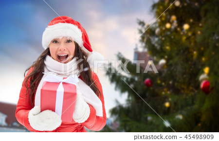 happy woman with gift over christmas tree 45498909