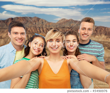 happy friends taking selfie over grand canyon happy friends taking selfie over grand canyon 45498976