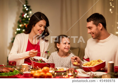 happy family having christmas dinner at home happy family having christmas dinner at home 45498978