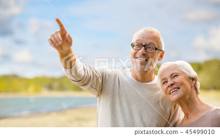 happy senior couple over beach background 45499010