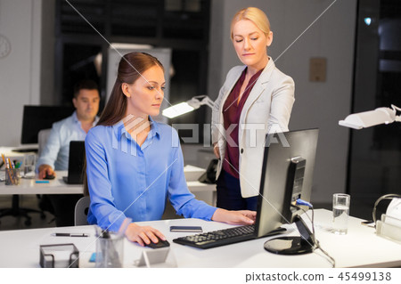 businesswomen with computer working late at office 45499138