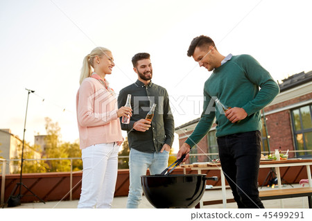 happy friends having bbq party on rooftop happy friends having bbq party on rooftop 45499291