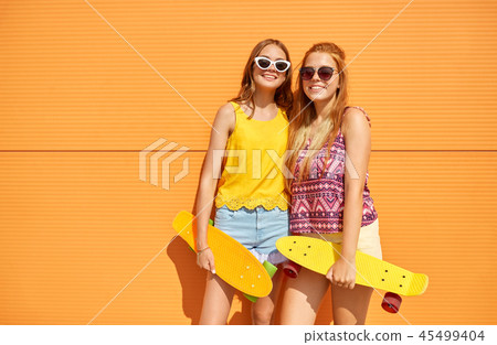 teenage girls with short skateboards outdoors teenage girls with short skateboards outdoors 45499404
