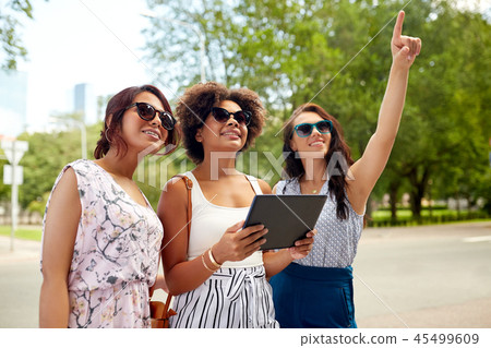 women with tablet pc on street in summer 45499609