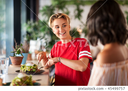 female friends eating at restaurant 45499757