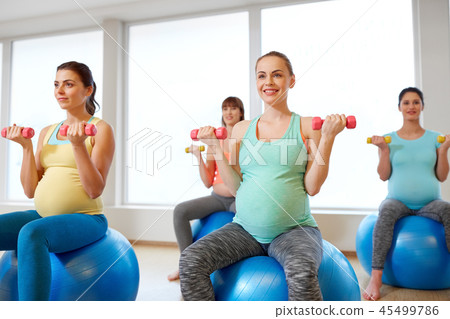 pregnant women training with exercise balls in gym 45499786