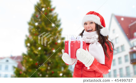 happy woman with gift over christmas tree 45499787
