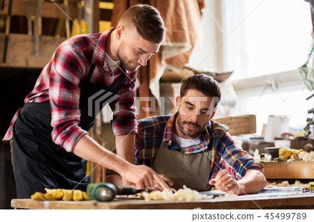 two carpenters working at workshop two carpenters working at workshop 45499789
