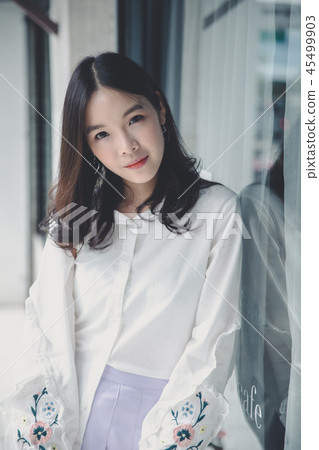 Portrait young woman thinking and looking modern style in outdoor urban background 45499903