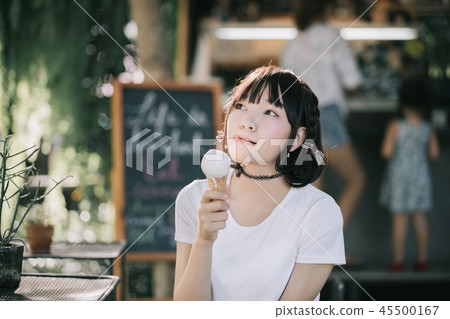 portrait of asian girl with white shirt and skirt looking in outdoor nature vintage film style 45500167