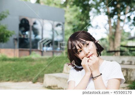 portrait of asian girl with white shirt and skirt looking in outdoor nature vintage film style 45500170