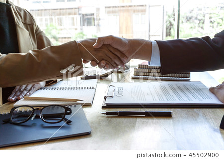 Finishing up a meeting, handshake of two happy business people a 45502900