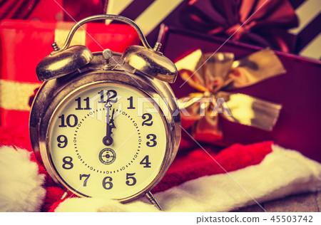 alarm clock on Santa Claus hat and gifts alarm clock on Santa Claus hat and gifts 45503742
