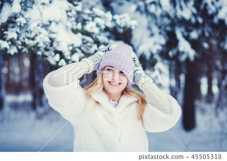Woman posing on snow background Woman posing on snow background 45505318