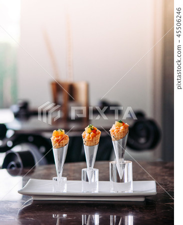 Salmon Tartare in mini waffle cones modern cuisine Salmon Tartare in mini waffle cones modern cuisine 45506246