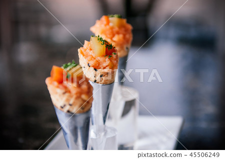 Salmon Tartare in mini waffle cones modern cuisine Salmon Tartare in mini waffle cones modern cuisine 45506249