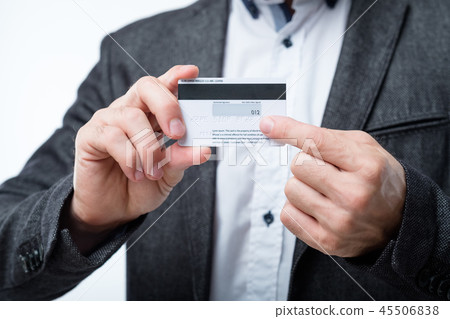 credit card security secret code number man hold 45506838