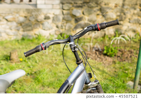 Bicycle handlebar on the lawn during active walks Bicycle handlebar on the lawn during active walks 45507521
