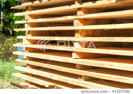 Wooden pallets stacked in the open air Wooden pallets stacked in the open air 45507590