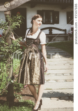 Young bavarian woman in holiday dirndl Young bavarian woman in holiday dirndl 45507886
