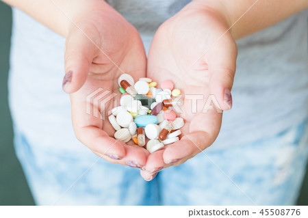 pills capsules hands painkiller prescription drugs 45508776