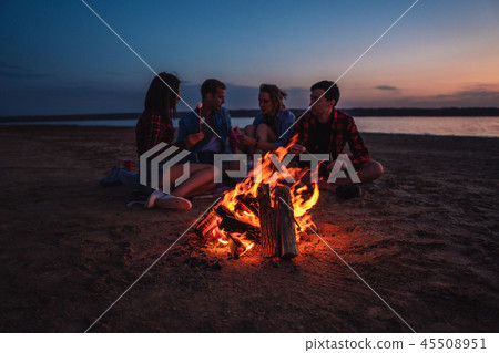 young friends have picnic with bonfire on the beach young friends have picnic with bonfire on the beach 45508951